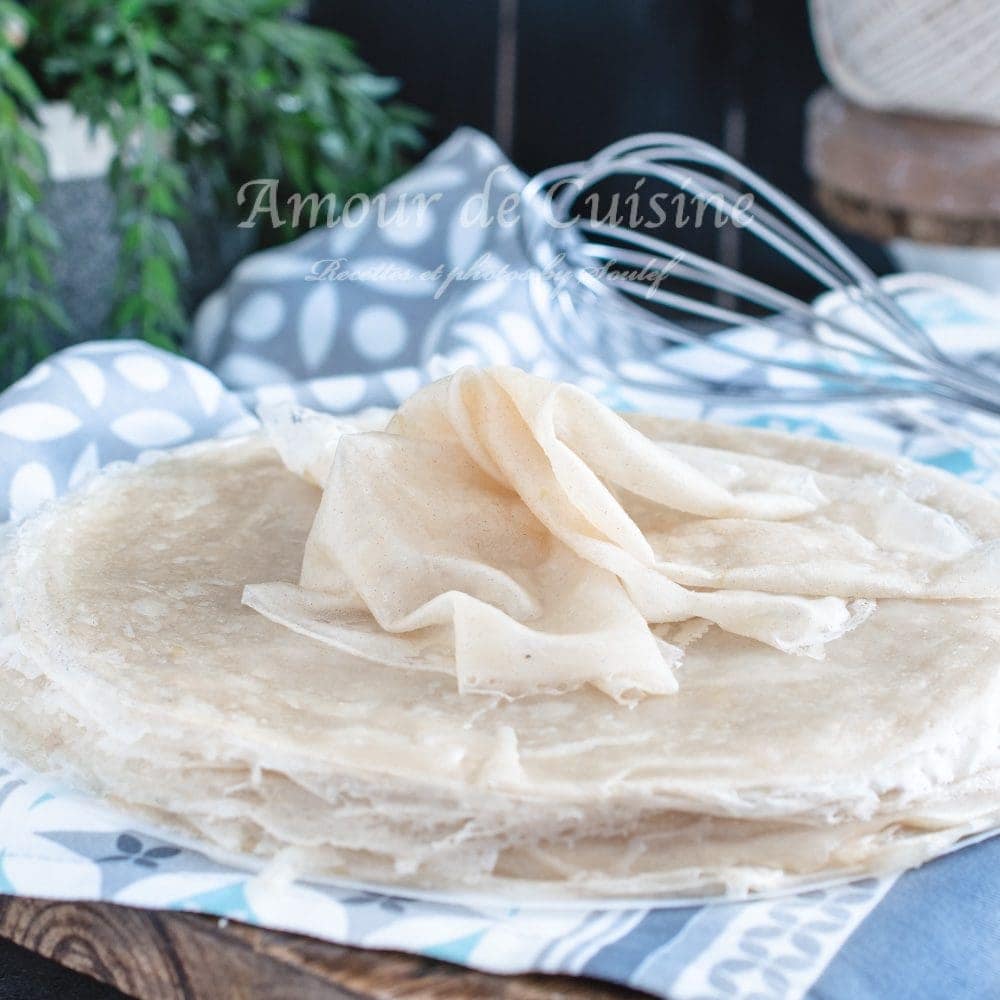 Brik pastry photo: Stack of homemade brik (malsouka) pastry sheets known as spring rolls wrappers on a wooden board, ready for stuffing